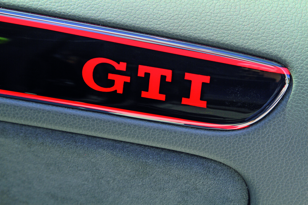Weltpremiere am Woerthersee: Golf GTI Black Dynamic/Praezision im Detail - von Hand lackierter roter GTI-Schriftzug auf Tuerinnenverkleidung.